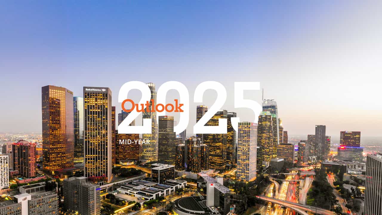 photo of an urban skyline with the words 2025 mid-year outlook interweaved between highrises